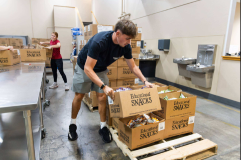 Volunteers packing education snacks