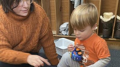 Greyson McKahan, 3, a student at Discovery Christian Dayschool in Coeur d'Alene plays with director Katrina Floyd. ELLI GOLDMAN HILBERT/Press